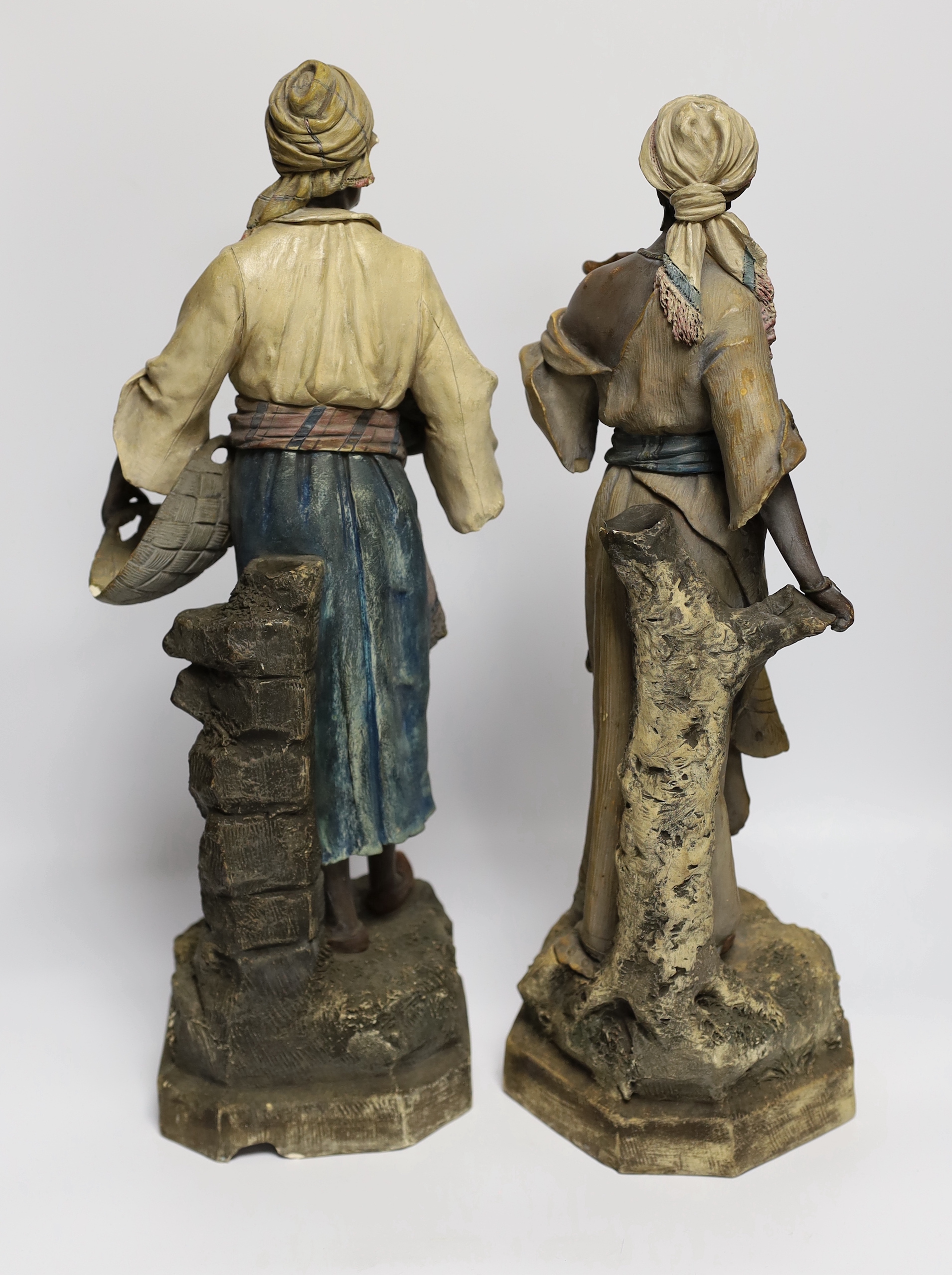 A pair of Goldscheider type Nubian figures, tallest 46cm